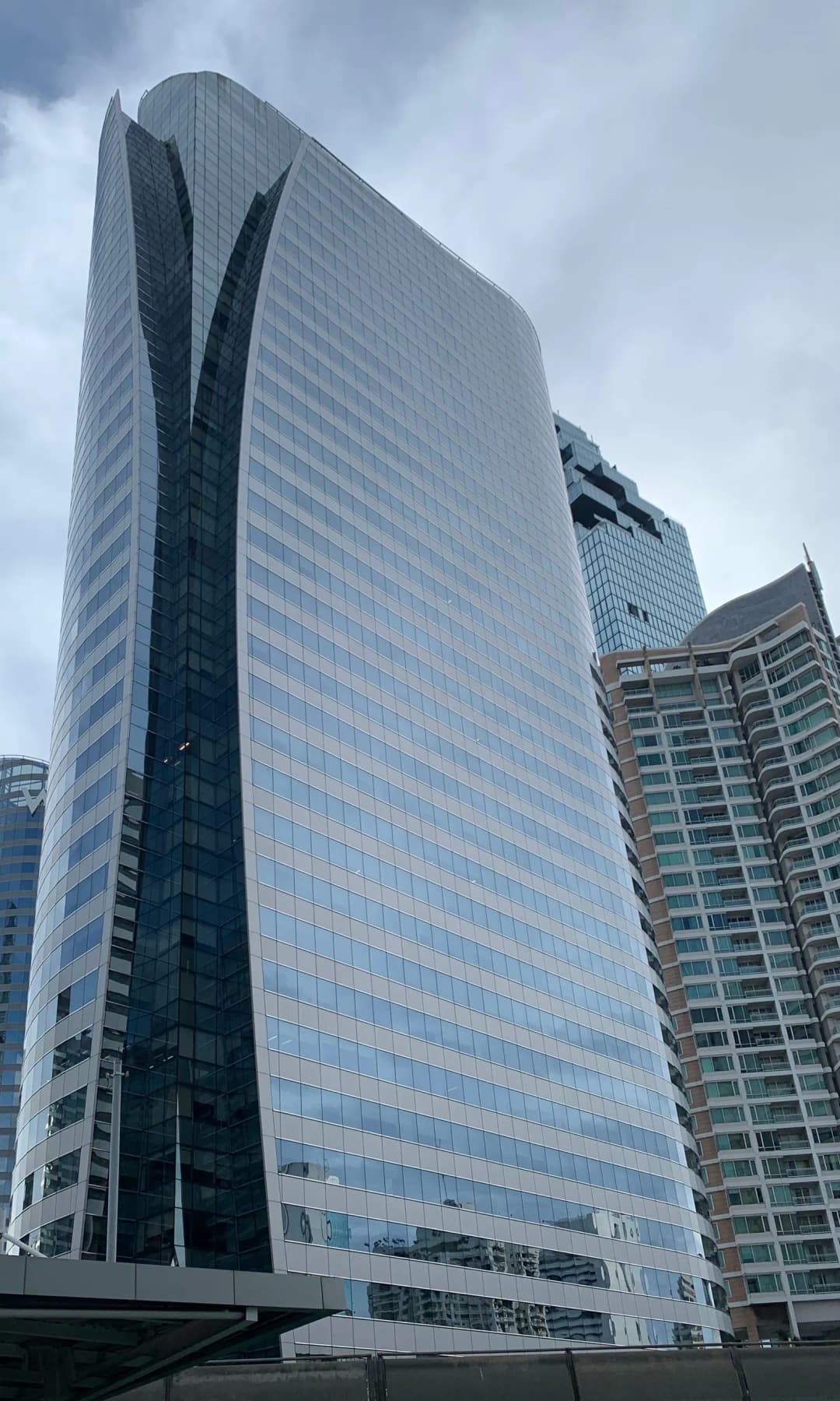 Curved glass office tower in the Sathorn business district of Bangkok