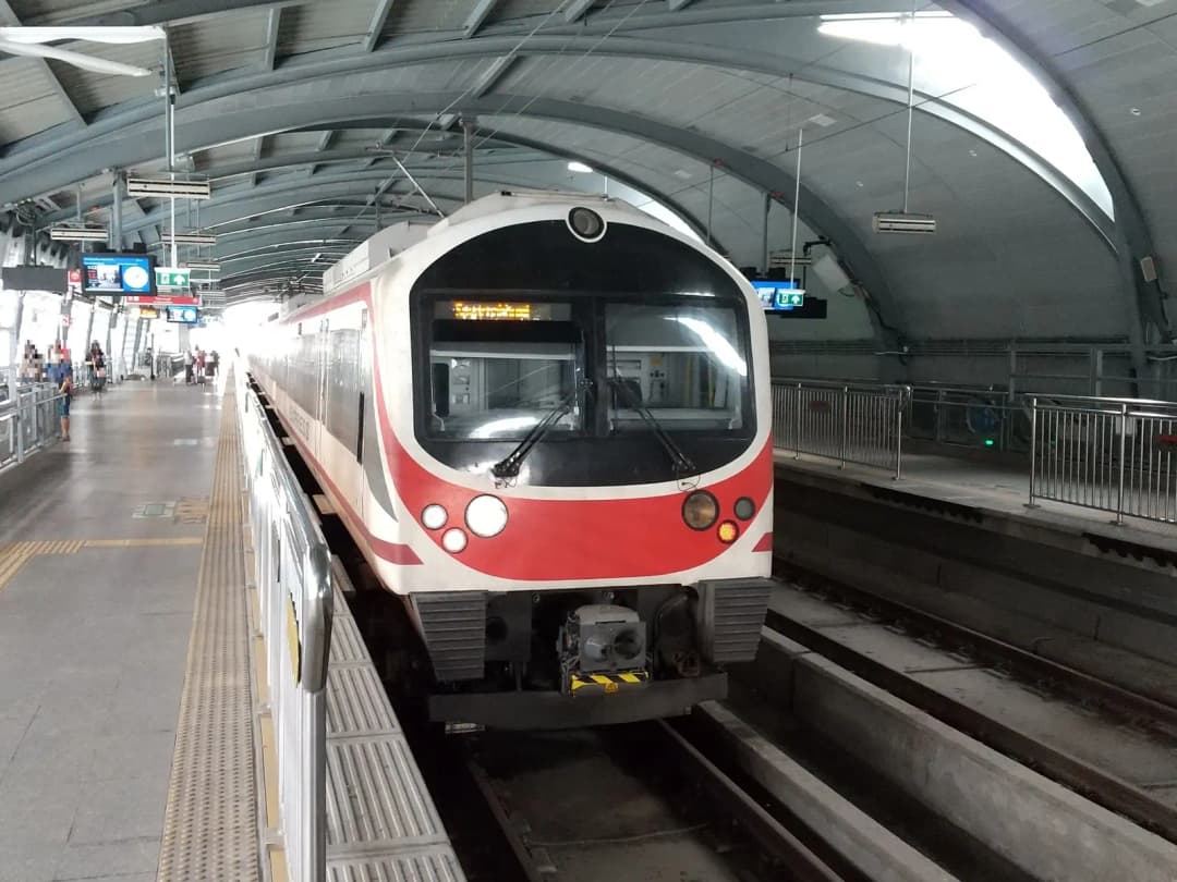 Red and white Airport Rail Link train waiting at the Phaya Thai station platform in Bangkok